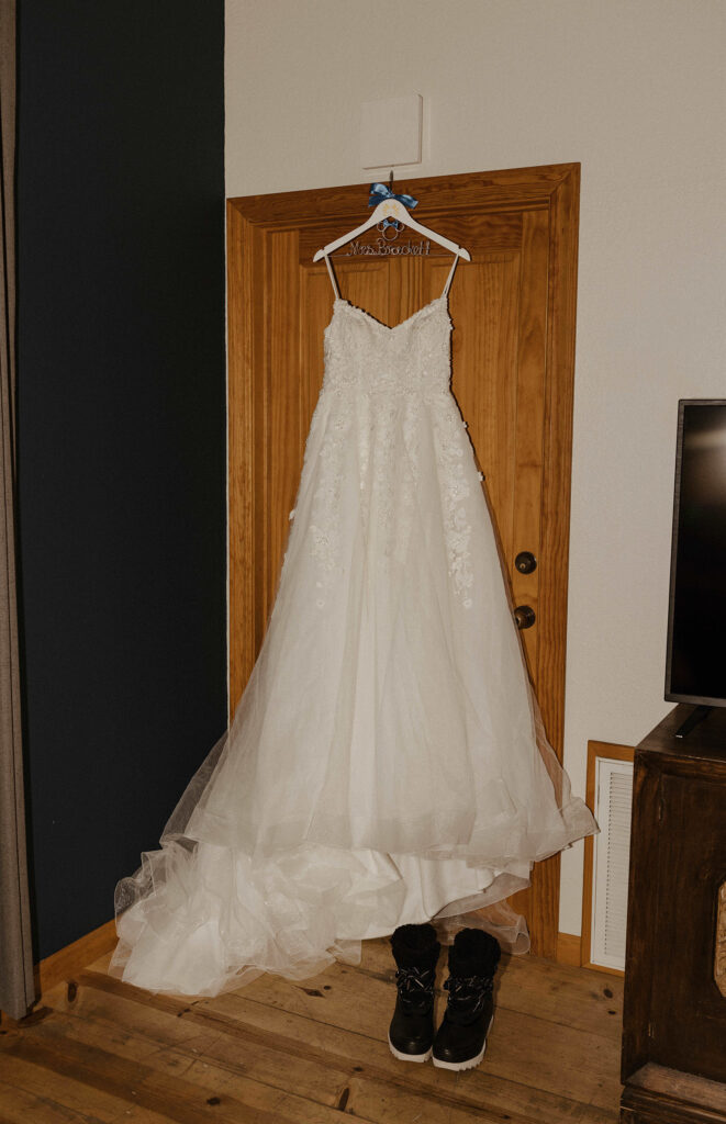 lace strapless wedding dress with snow boots next to them