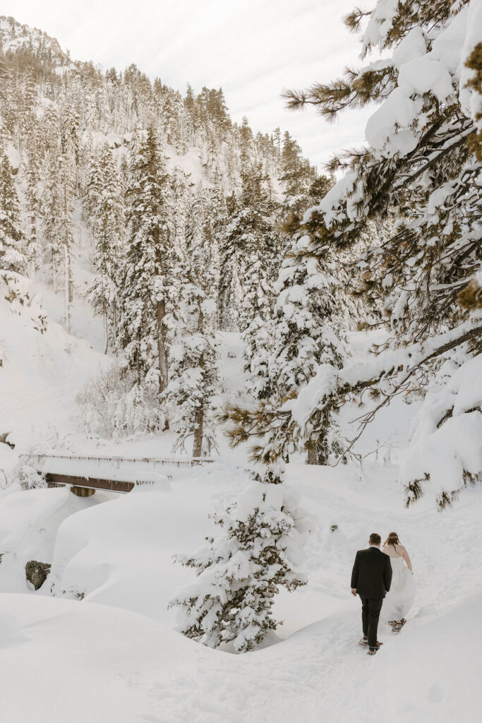 elopement couple hiking in the snow in lake tahoe in the winter