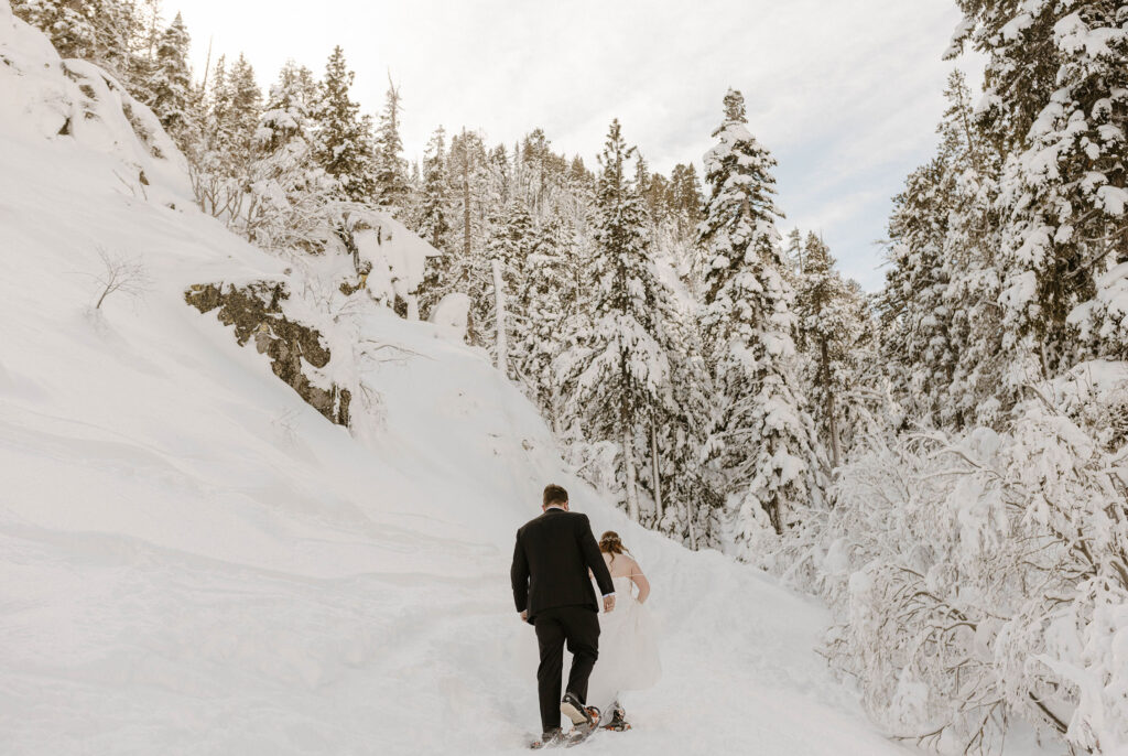 elopement couple hiking through the snow in lake tahoe