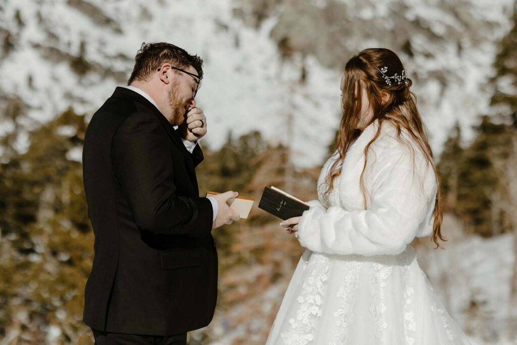 elopement couple sharing vows in lake tahoe while the groom wipes his tears