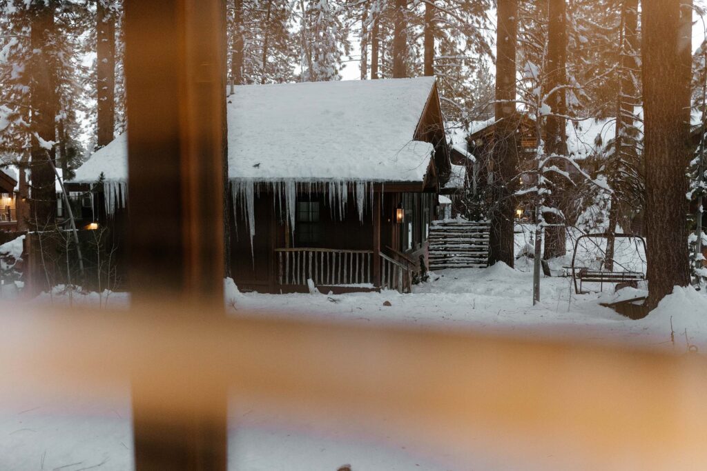 looking through the windows with snow cabins and icicles outside