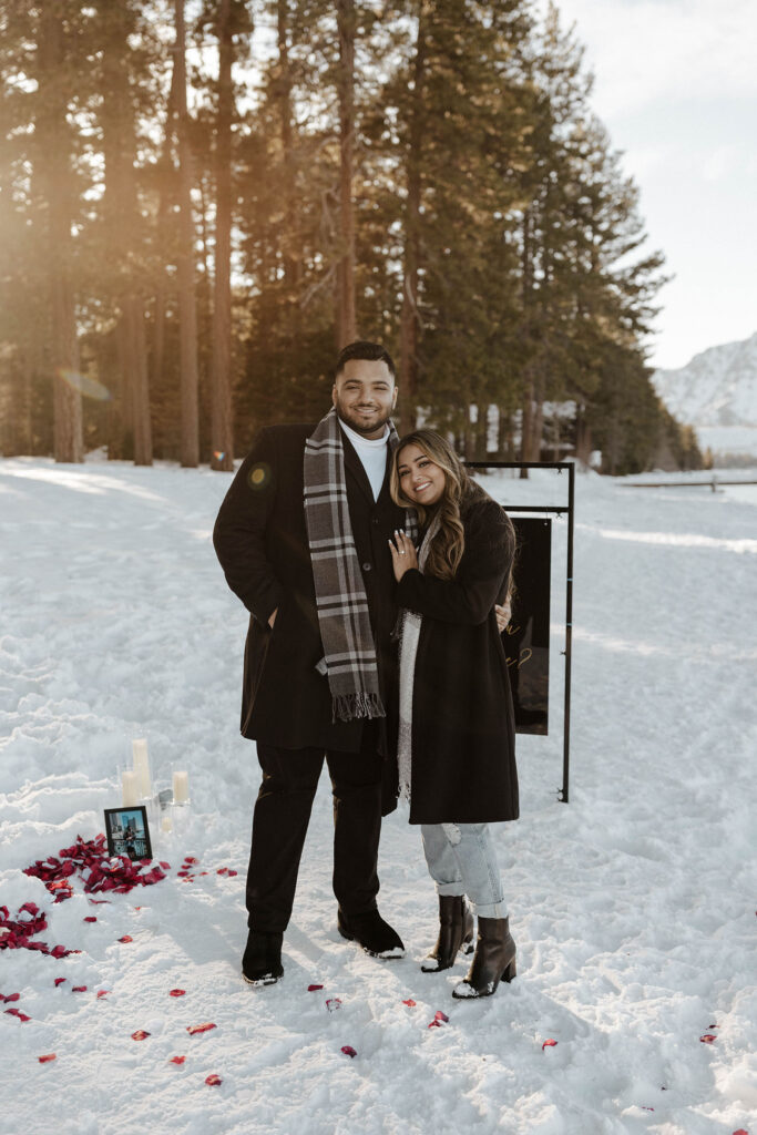 newly engaged couple smiling at the camera in south lake tahoe in the winter