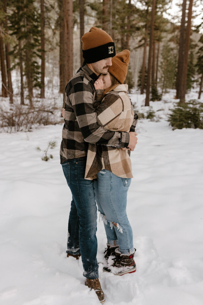 couple hugging in the winter in lake tahoe