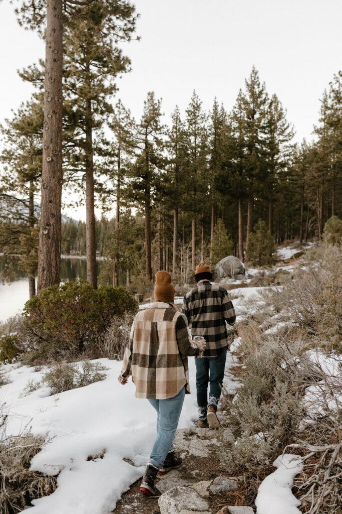 couple walking in lake tahoe in the winter 