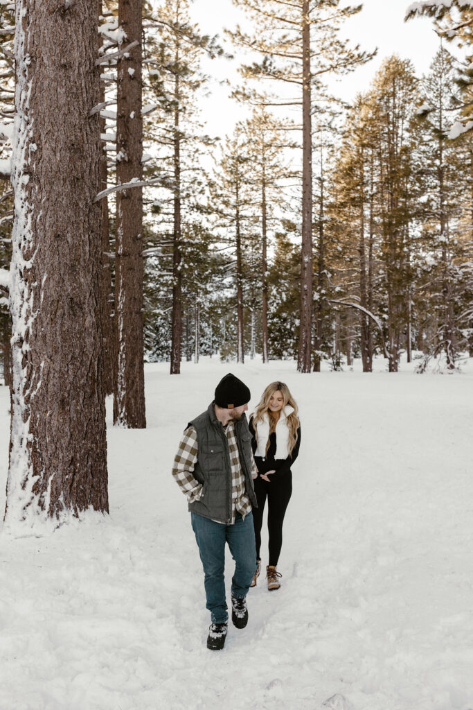maternity couple walking in the snow in lake tahoe