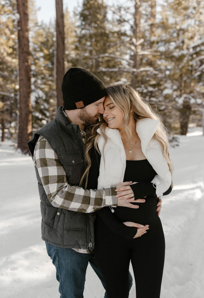 maternity couple smiling and hugging in lake tahoe 