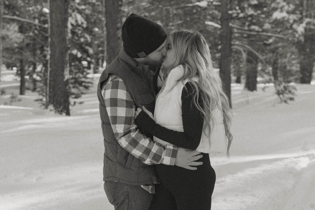 maternity couple kissing in the snow in lake tahoe