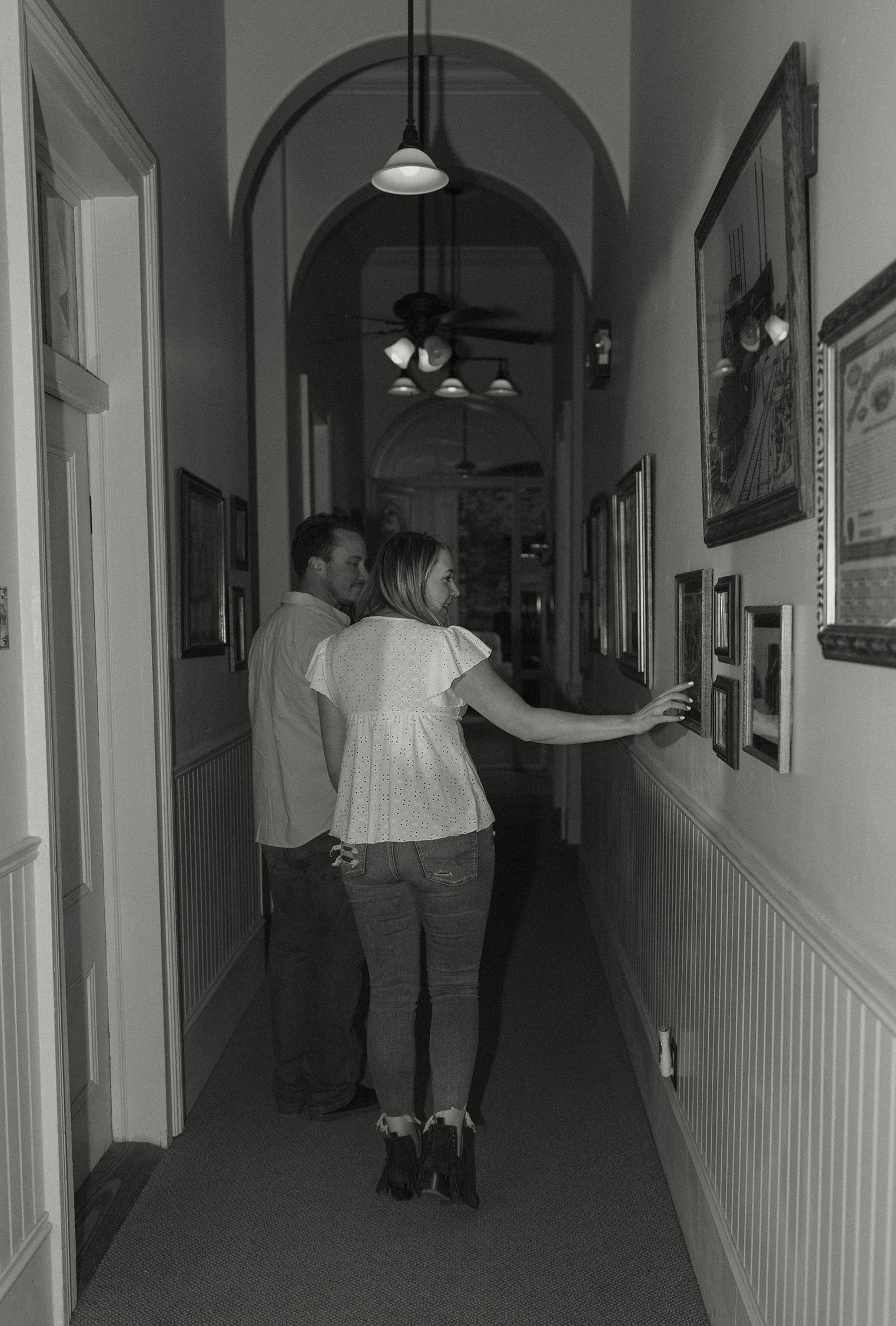 engagement couple looking at artwork on the walls in virginia city