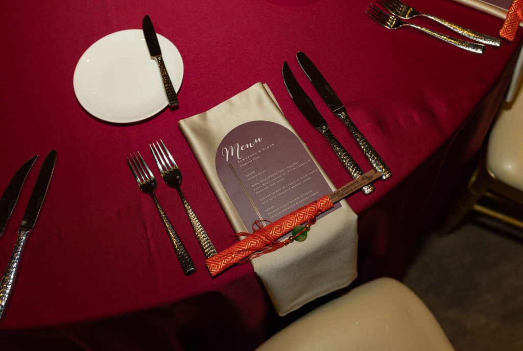 maroon wedding menu and table seating at the whitney peak