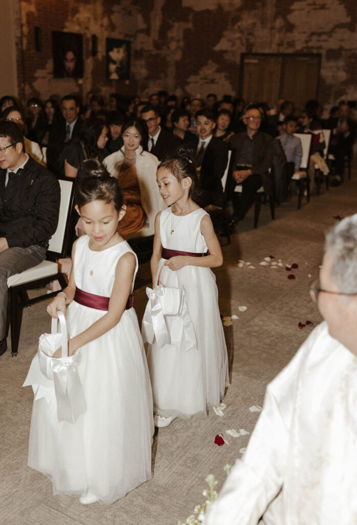 flower girls dropping flower petals for a winter wedding at the whitney peak hotel