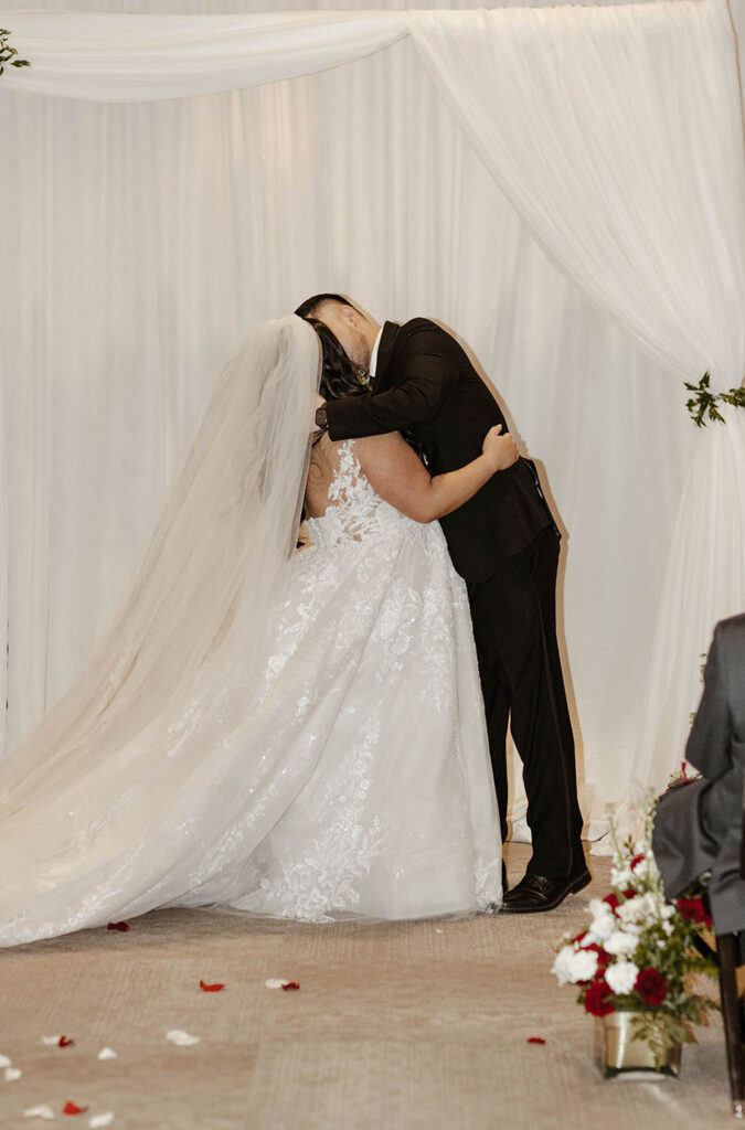 bride and groom first kiss at their ceremony at the whitney peak hotel