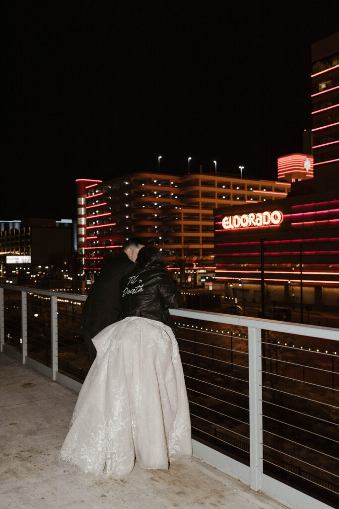 bride and groom overlooking the eldorado at night at the whitney peak hotel