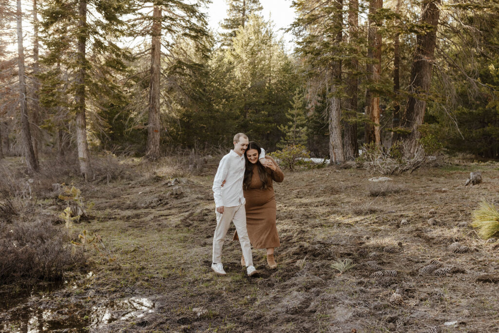Engagement couple with arms around each other walking through Lake Tahoe forest