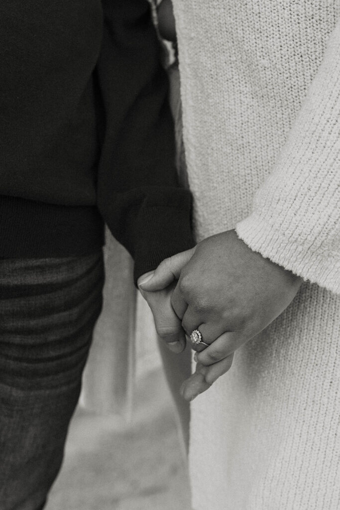 Close up of engagement couple holding hands while wearing engagement rings in Lake Tahoe