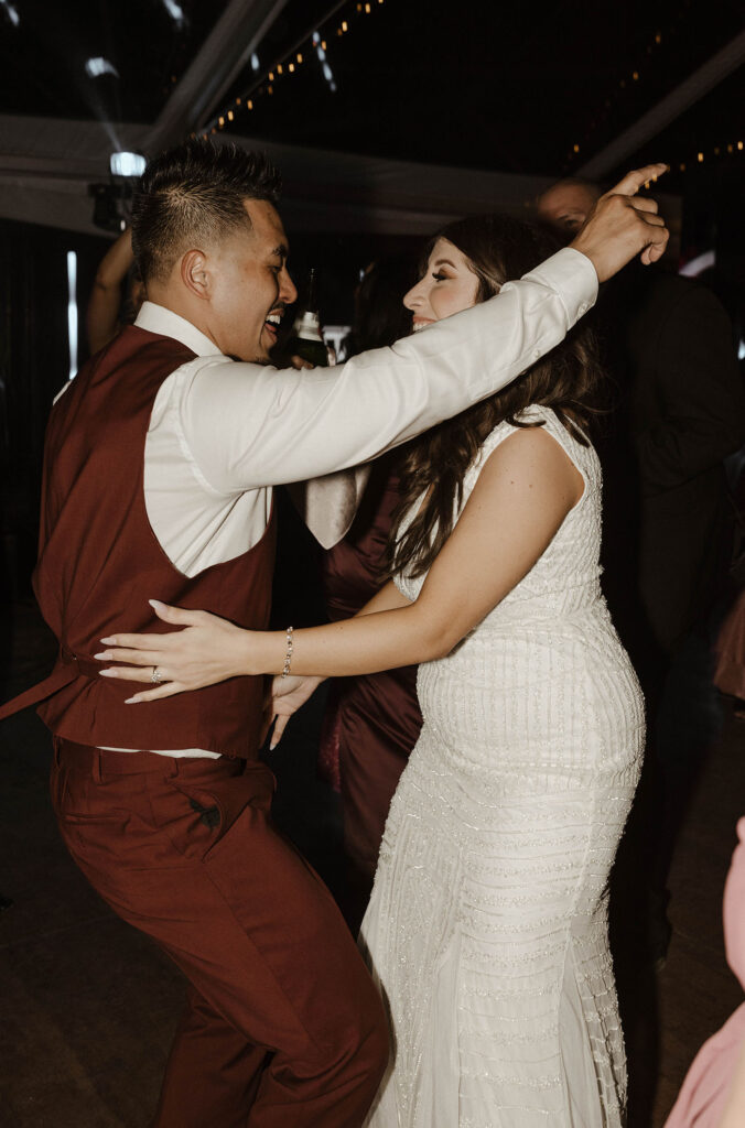 Wedding groom dancing and celebrating with bride at Chalet View Lodge