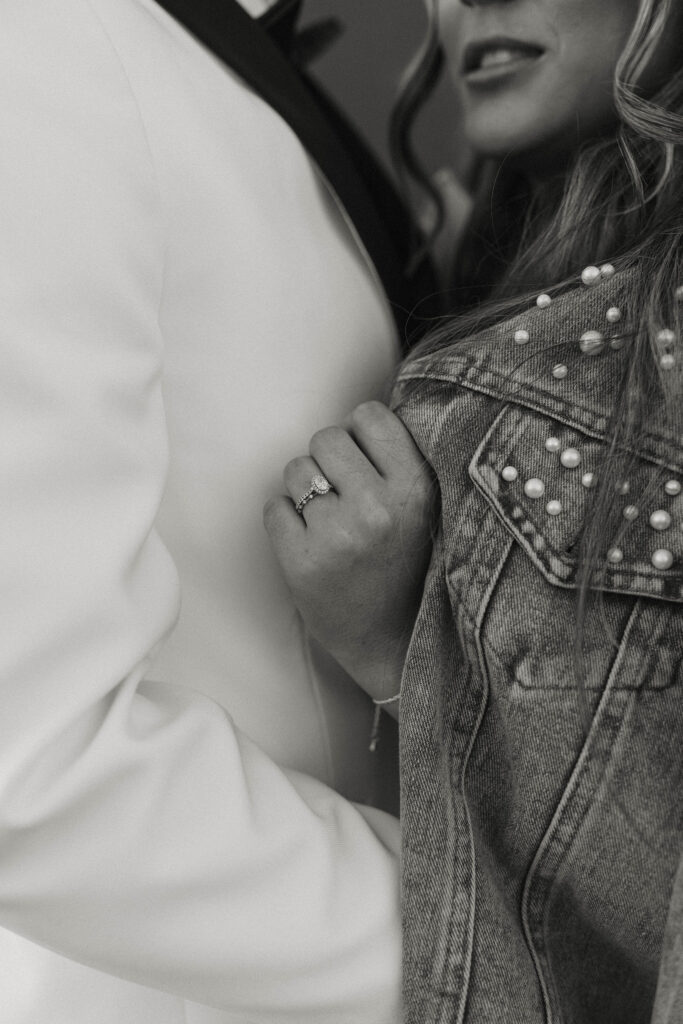 Close up of wedding couple holding each other with wedding rings at little bear creek ranch
