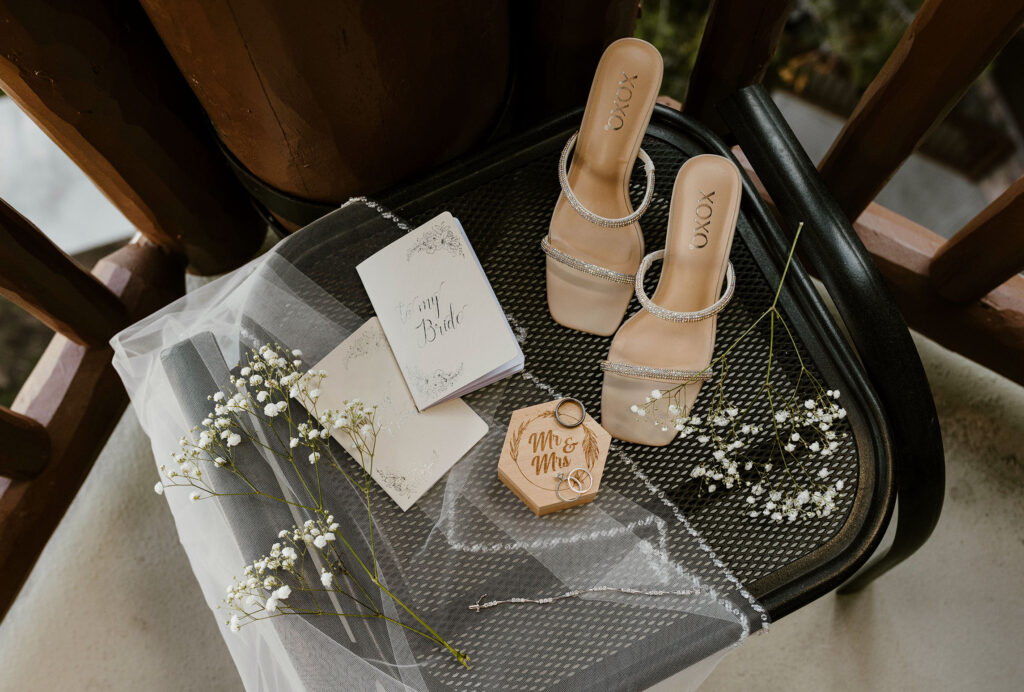 Elopement detail flat lay with wedding rings and brides shoes in Lake Tahoe