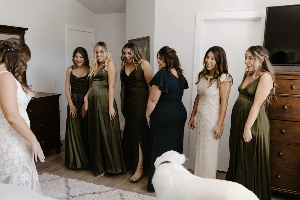 Bridesmaids and moms reacting during first look with bride in wedding dress in Lake Tahoe
