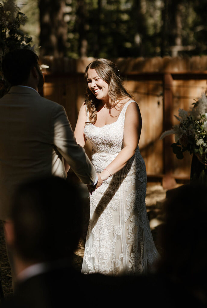 Bride smiling and laughing during wedding ceremony in Lake Tahoe