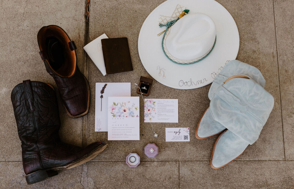 Wedding details in flat-lay with boots and hat on stone floor at Jacobs Berry Farm
