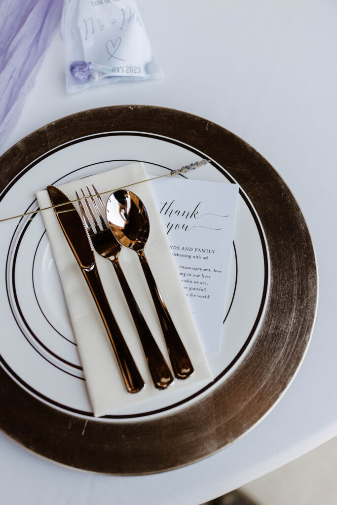 Wedding reception dinner plate with copper accenting on white table at Jacobs Berry Farm