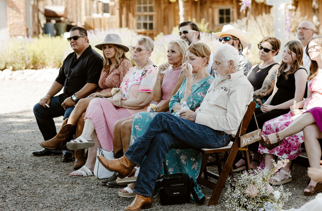 Wedding guests emotional and drying tears while watching ceremony at Jacobs Berry Farm