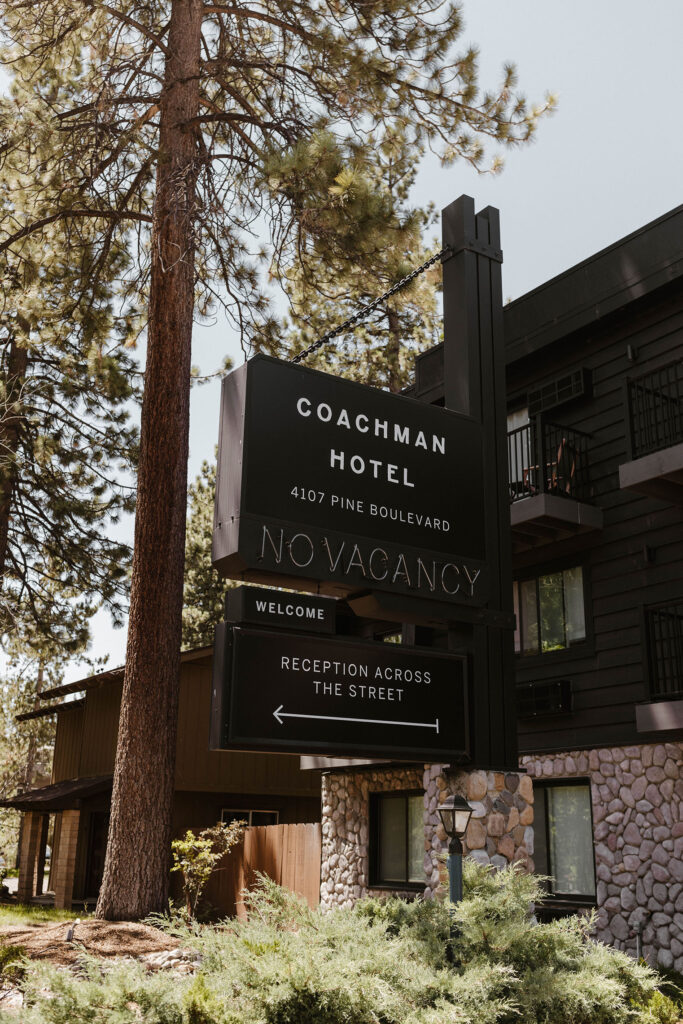 Coachman hotel sign on side of building with stone accenting in Lake Tahoe