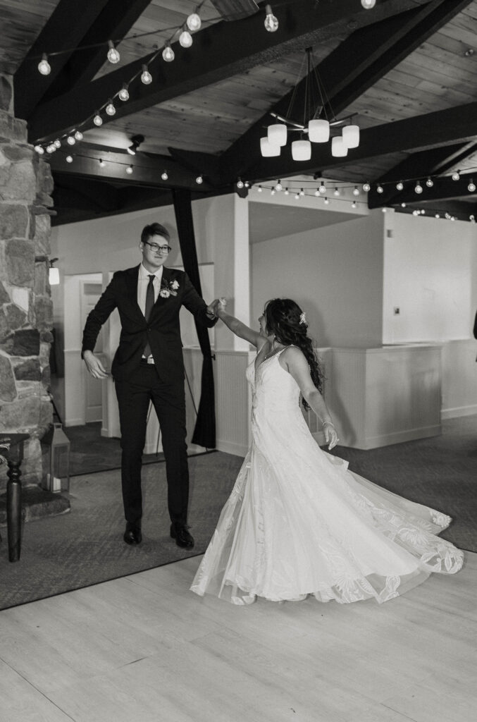 Wedding couple dancing with arms outstretched during their grand entrance at wedding ceremony at the Tannenbaum