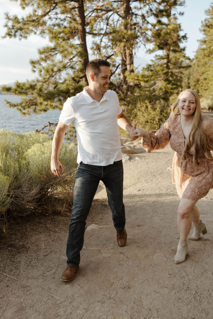 maternity couple running towards the camera laughing in lake tahoe in the summer 