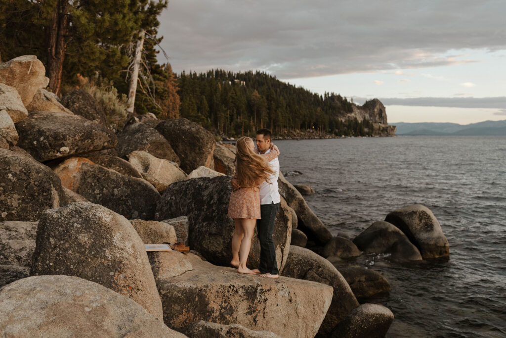couple dancing on a rock at sunset in lake tahoe 