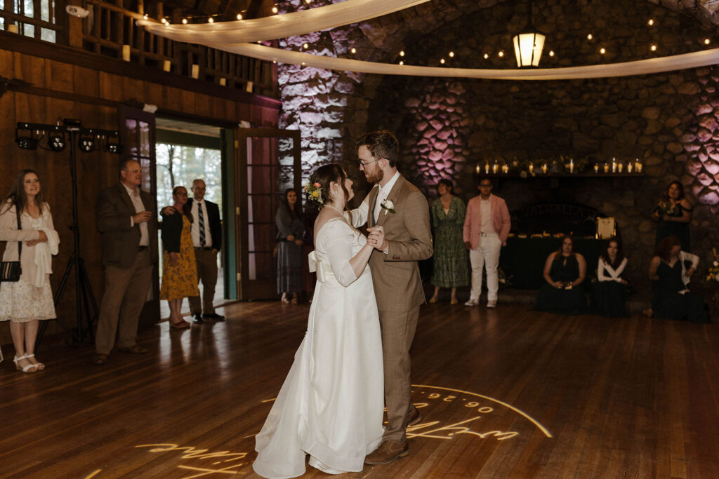 Wedding couple on dance floor dancing together with guests all around watching at Valhalla in Lake Tahoe