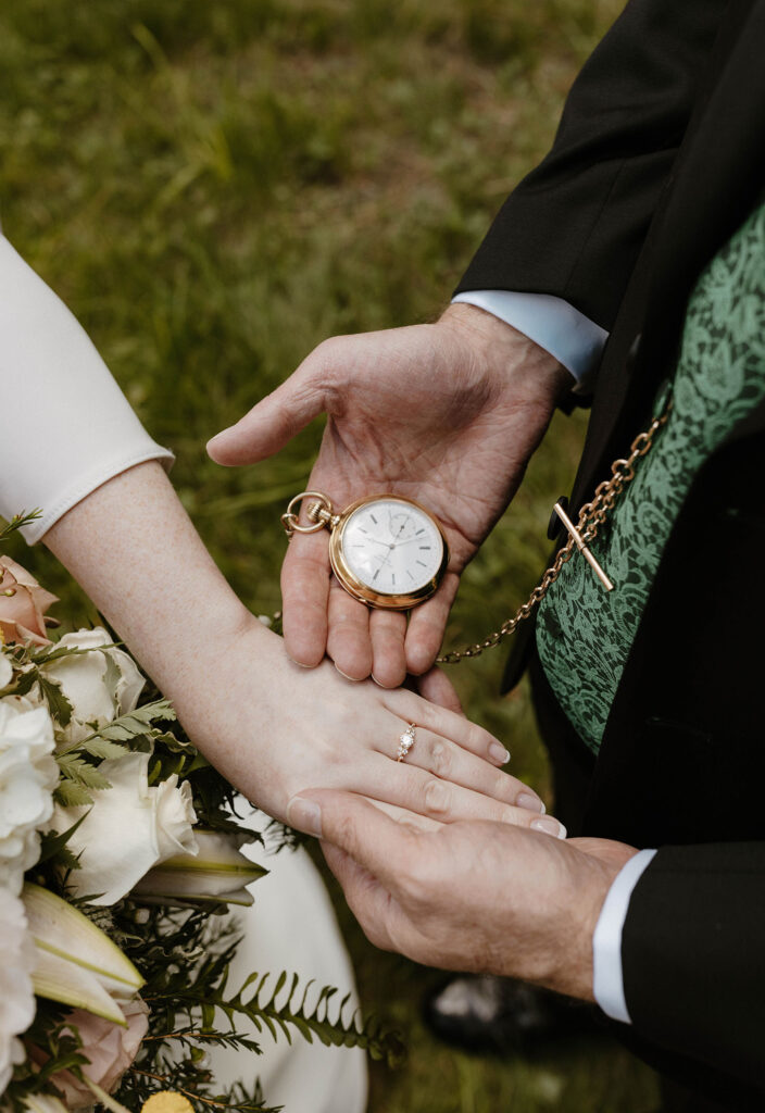 Dad holding out pocket watch next to wedding brides hand and wedding ring at Valhalla in Lake Tahoe