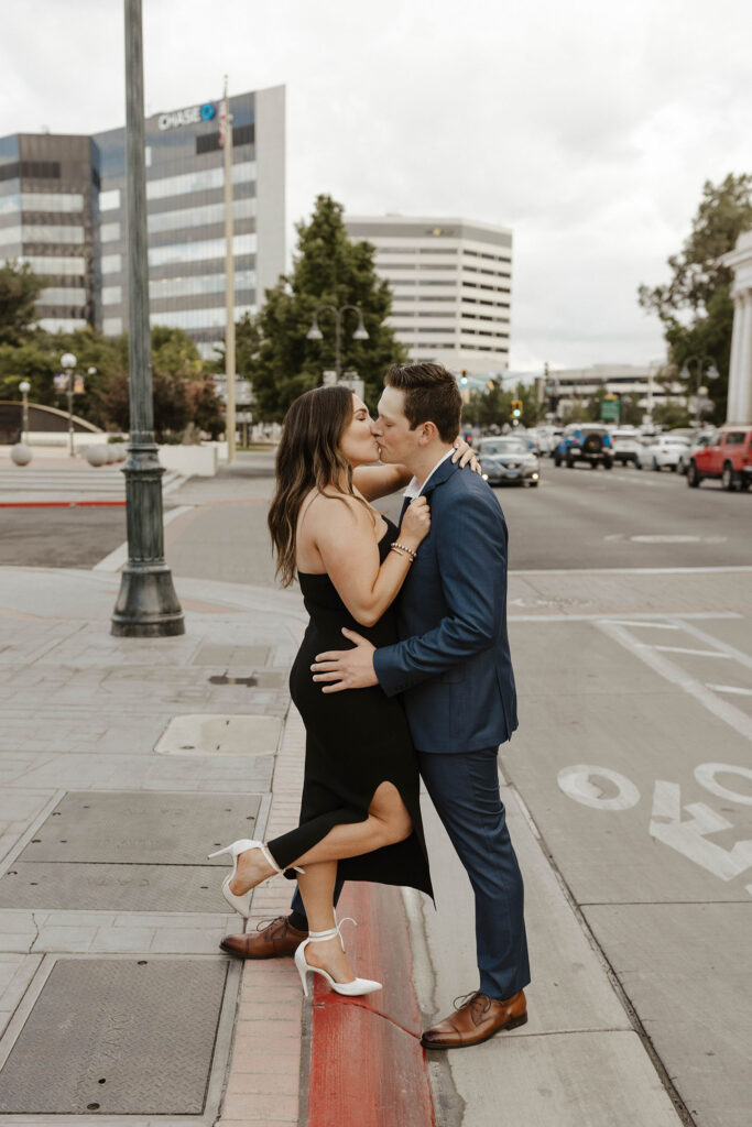 Couple kissing while standing partially in street in downtown Reno