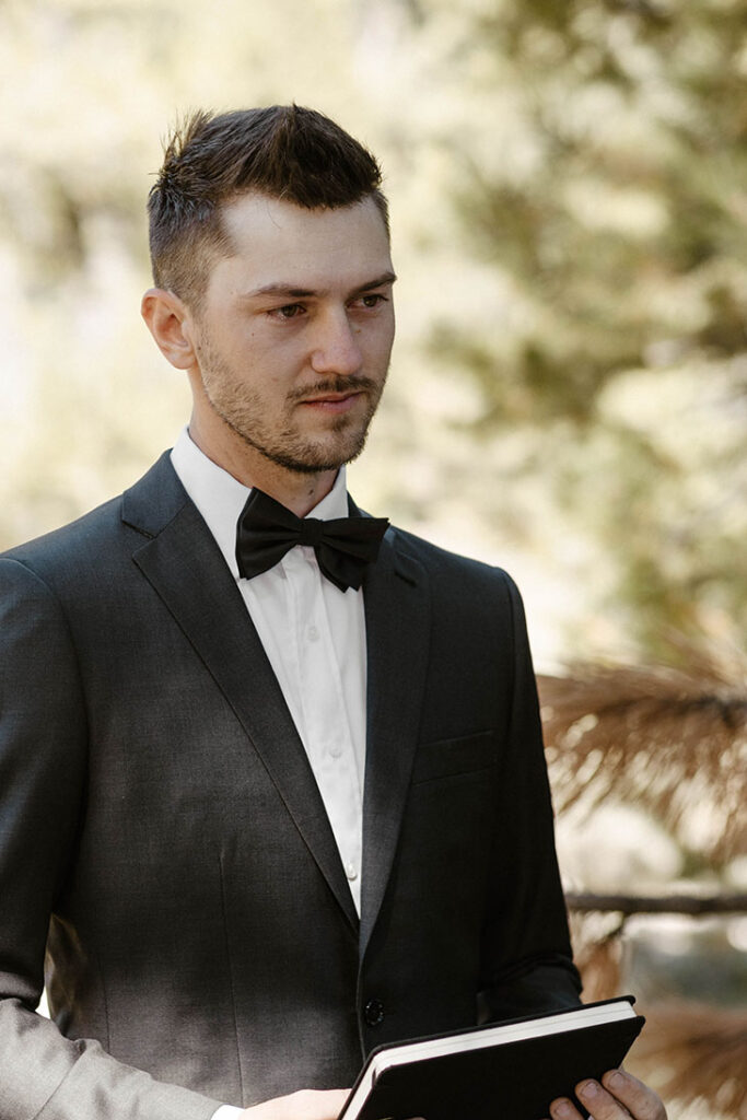 Groom emotional while listening to bride read vows at dancing pines