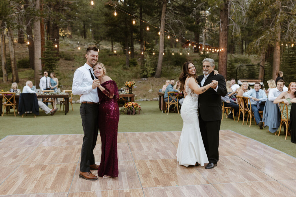 Wedding couple dancing with each of their parents during reception at dancing pines