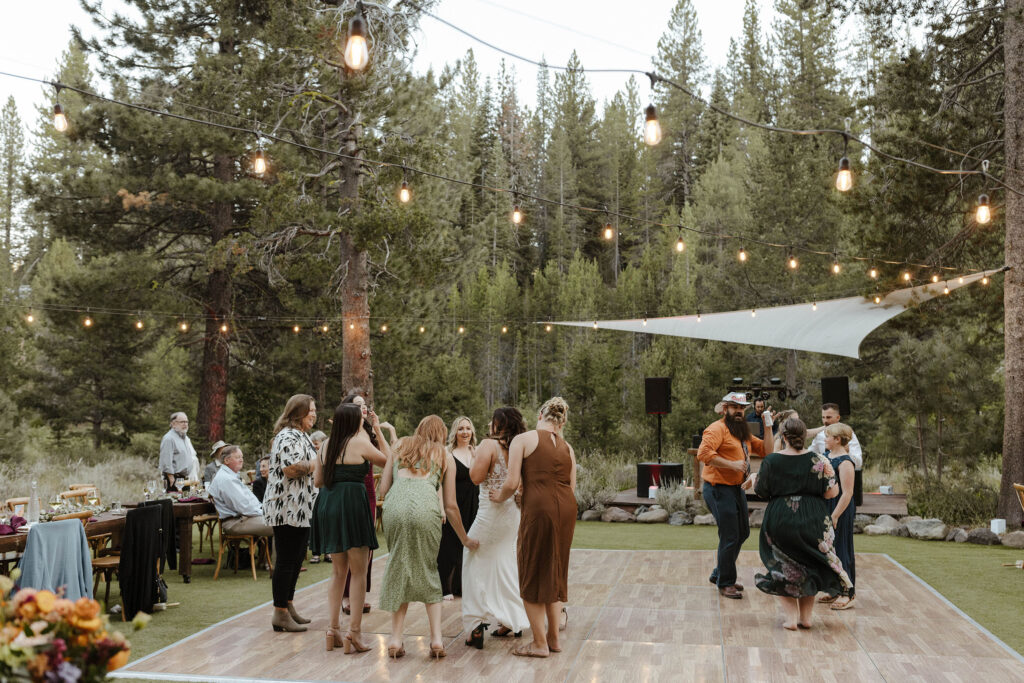 Wedding guests dancing and having fun during reception at dancing pines
