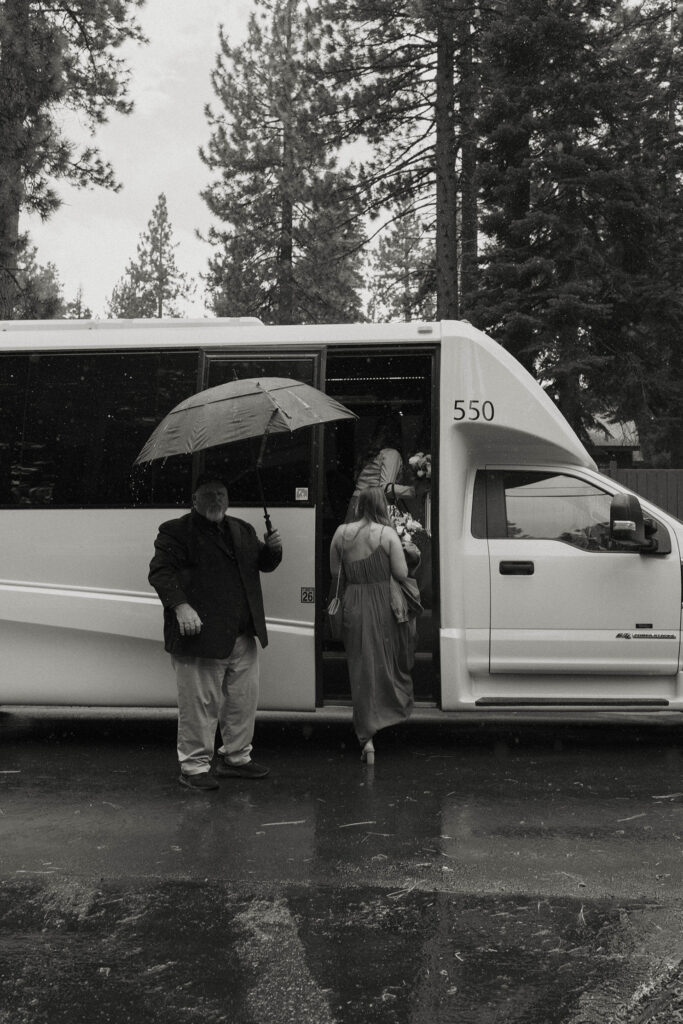 Bridesmaids getting into shuttle while it rains at Aspen Grove