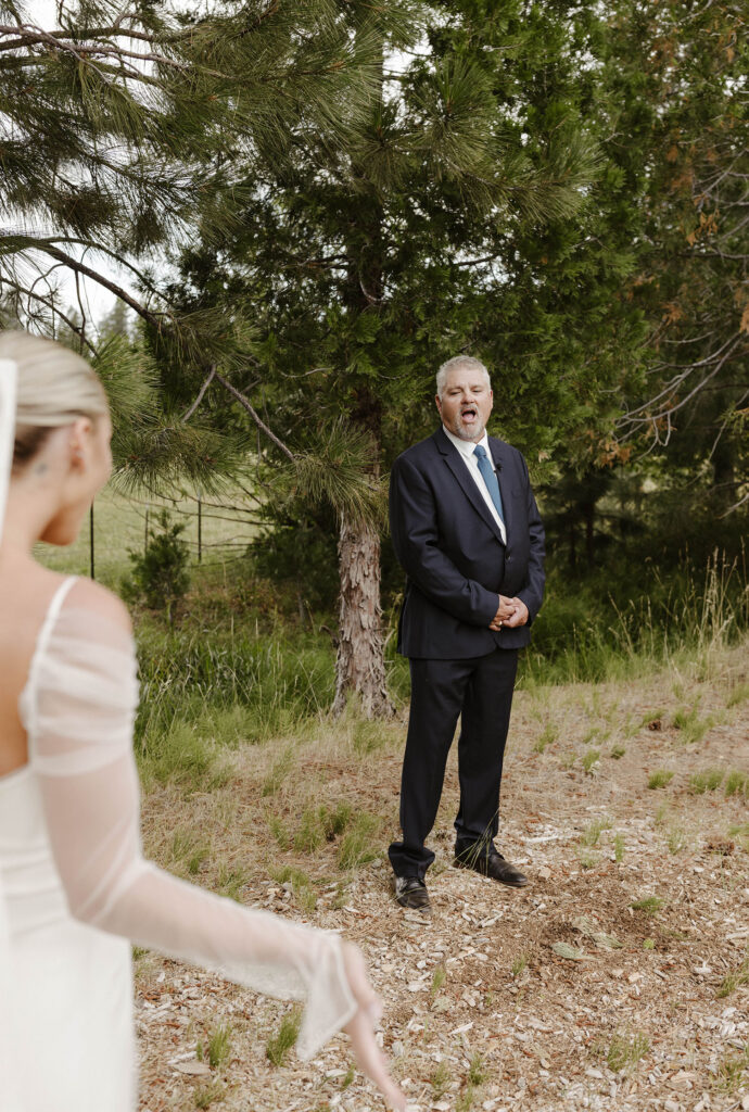 bride and her dad having a first look at her summer wedding at kinship ranch