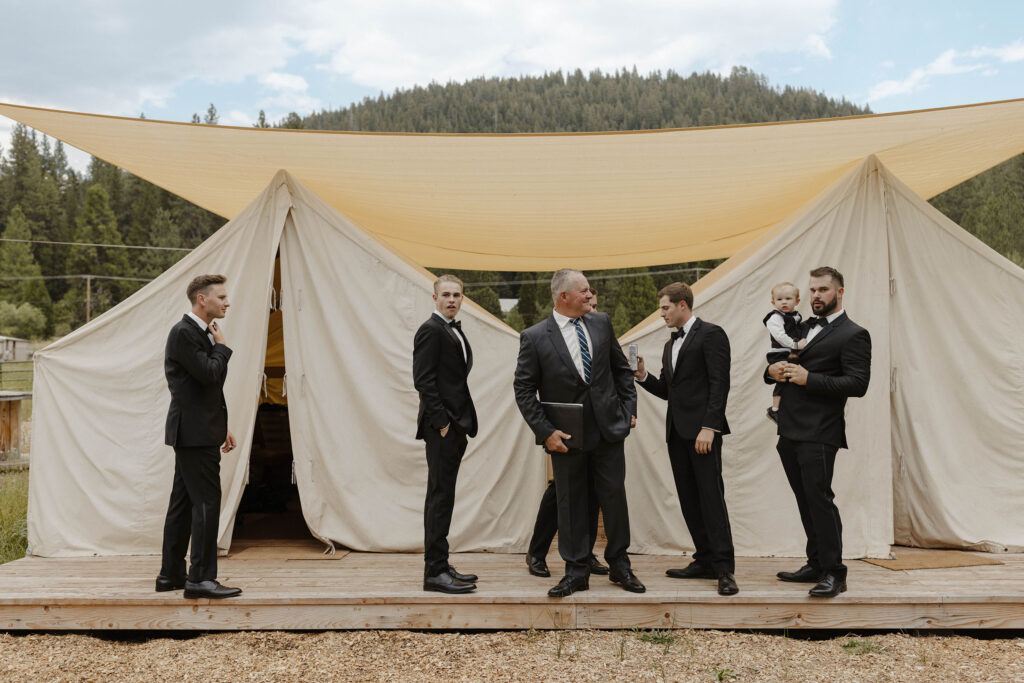groomsmen getting ready outside the tents at kinship ranch