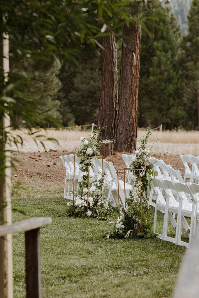 summer ceremony aisle florals with white roses and greenery 