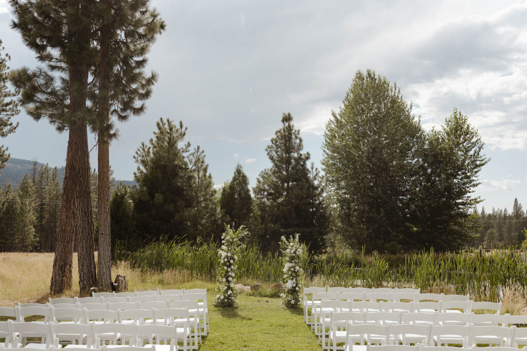 half floral arch with white roses and greenery at the end of the ceremony at kinship ranch