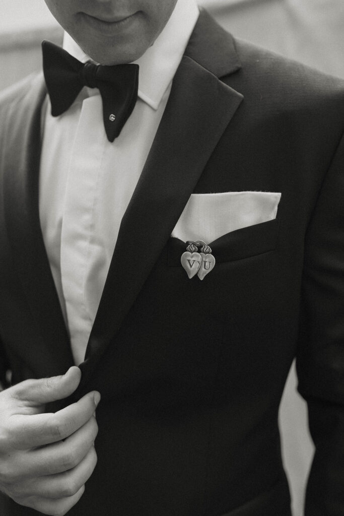 close up black and white photo of the grooms suit and details at kinship ranch