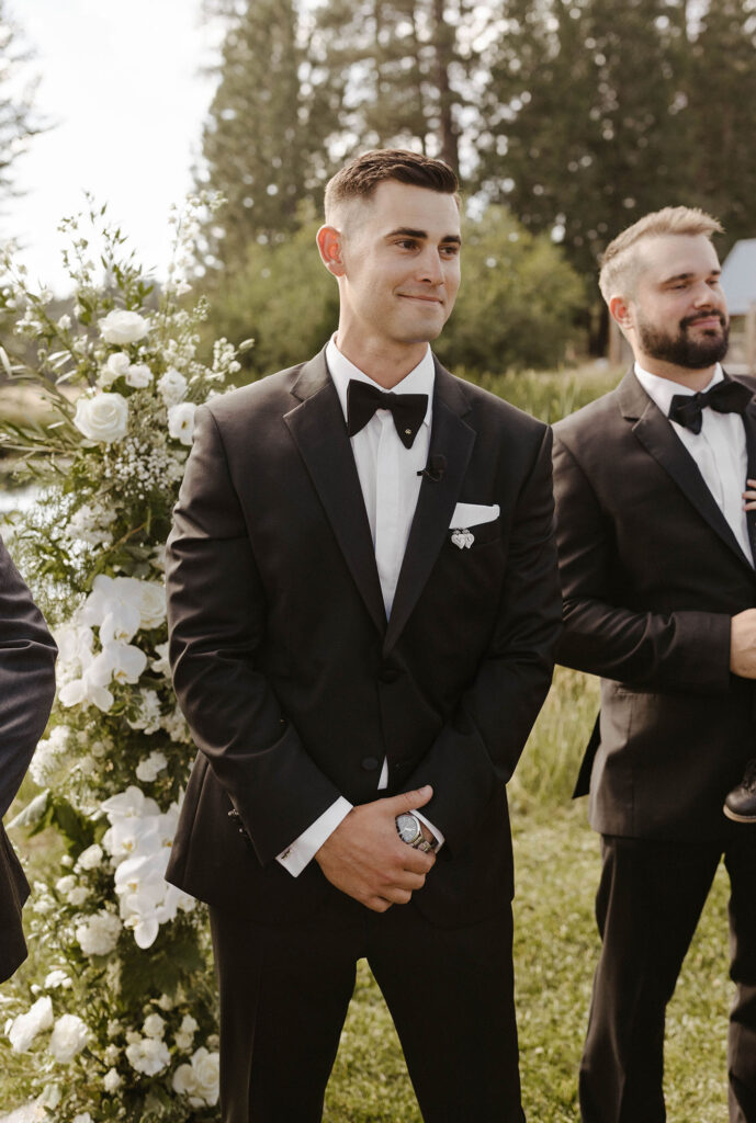 groom smiling seeing his bride for the first time during their summer wedding at kinship ranch
