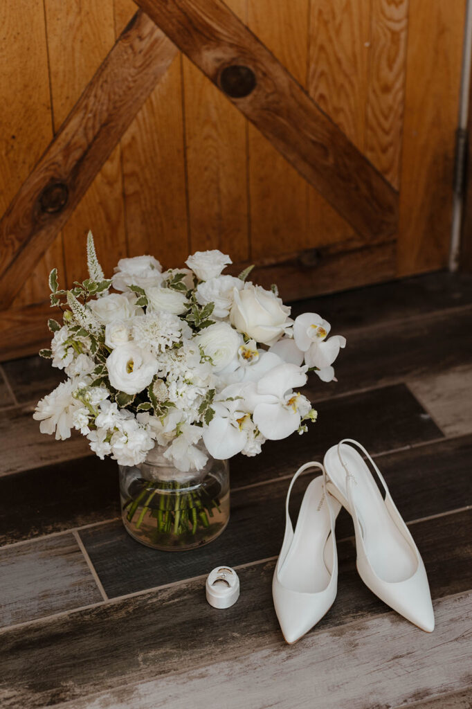 white wedding heels and white floral bouquet at kinship ranch