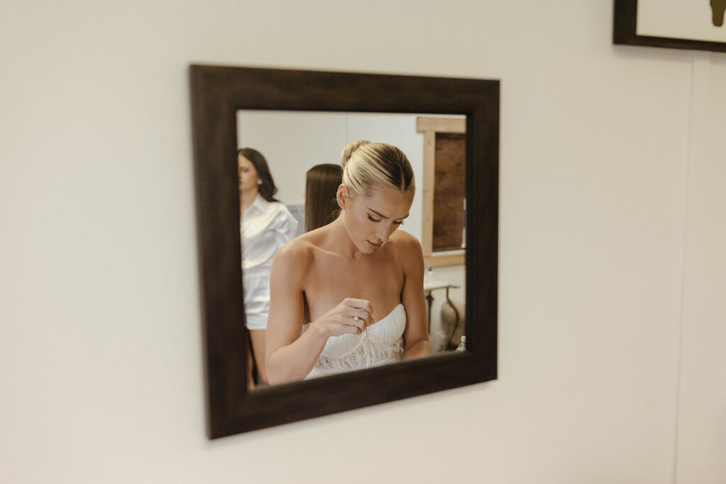bride getting ready from the perspective of of a mirror at kinship ranch