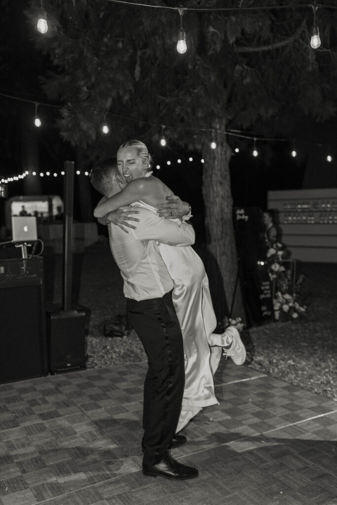 bride and groom hugging after their first dance at their summer wedding at kinship ranch