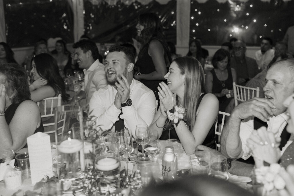 Wedding guests laughing during speeches at Willow Heights mansion