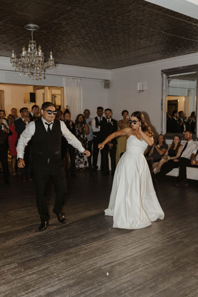 Bride party dancing with dad while both are wearing glasses during reception at Willow Heights mansion