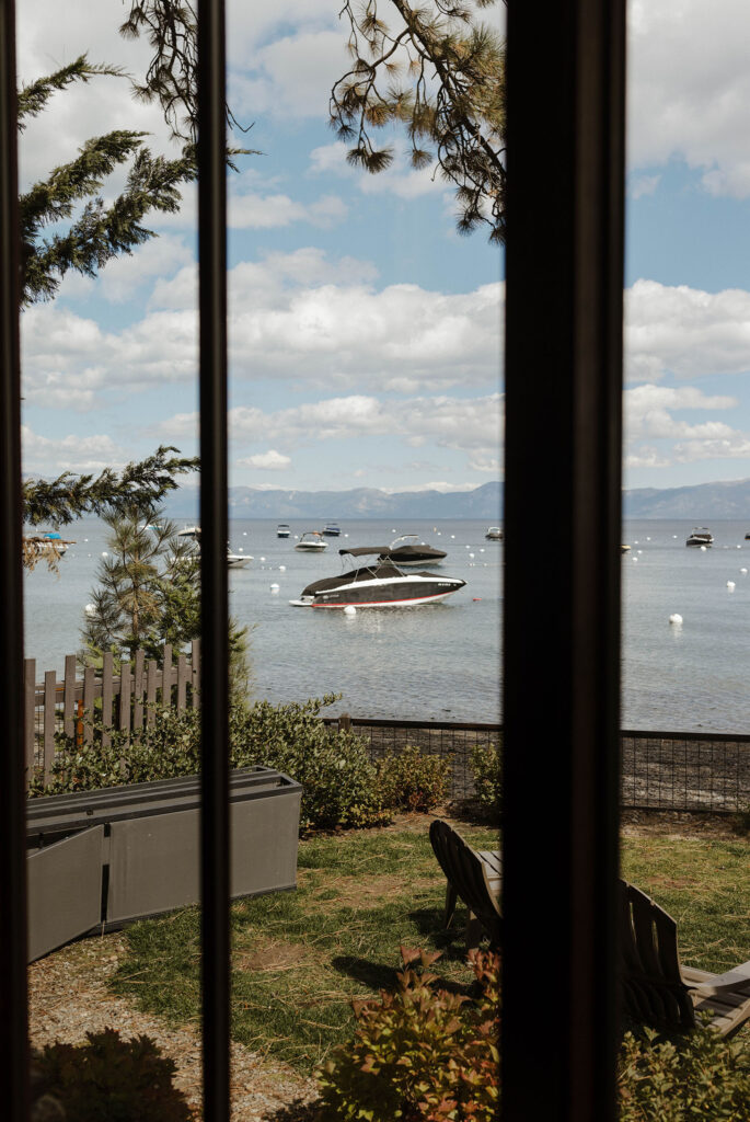 Boats docked in the harbor at Lake Tahoe through a window inside at the PlumpJack Inn