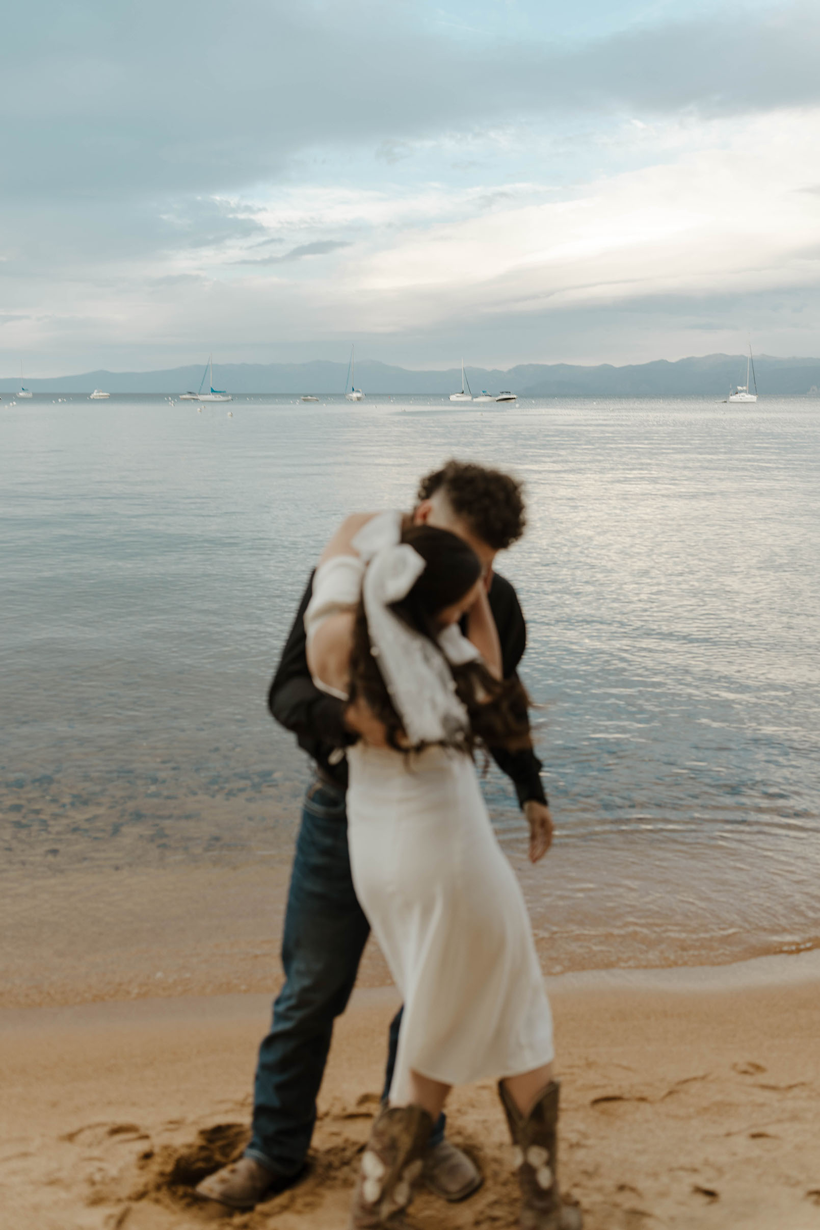 engagement couple dancing on the beach in south lake tahoe